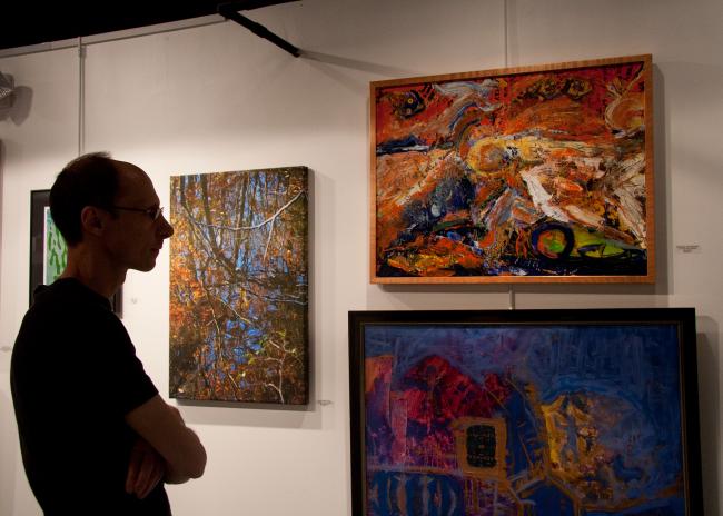 Art Collector viewing Christina Jarmolinski's Mixed Media Abstracts by Rob de Koter